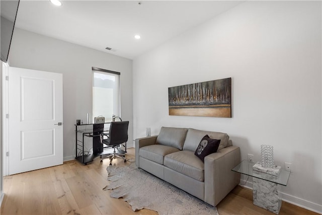 living room featuring wood finished floors, a desk, recessed lighting, and baseboards