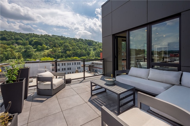 view of patio / terrace with a balcony and an outdoor living space