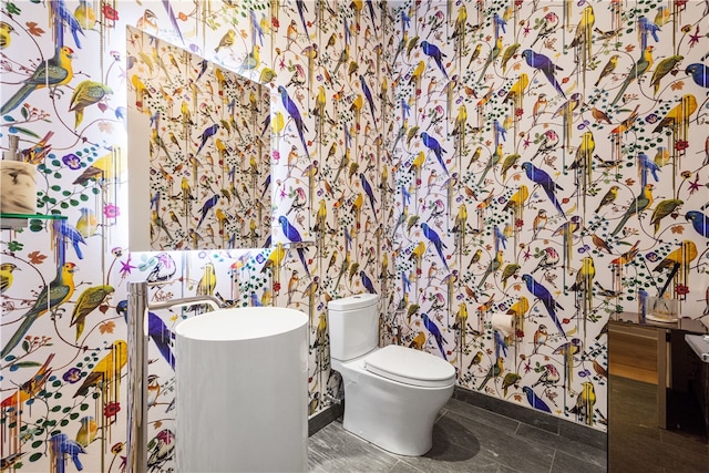 bathroom with toilet and tile patterned floors