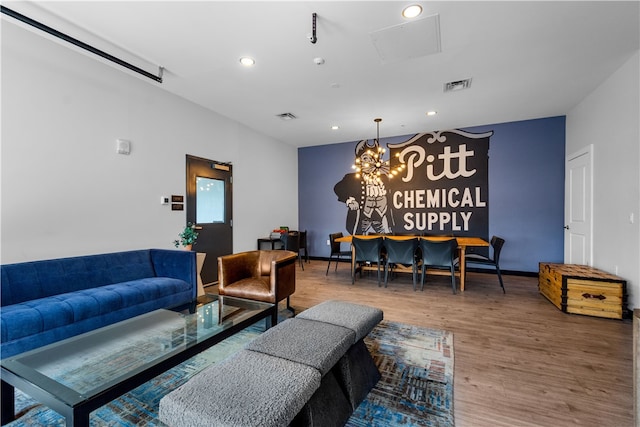 living room featuring hardwood / wood-style flooring and a chandelier