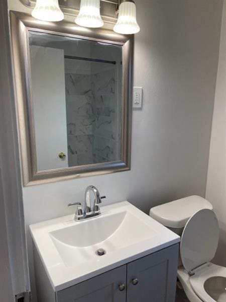 bathroom featuring vanity and toilet