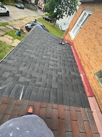 exterior details with roof with shingles