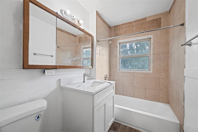 full bathroom with wood-type flooring, vanity, toilet, and tiled shower / bath