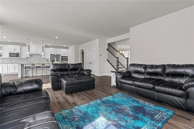 living room with dark hardwood / wood-style flooring and a chandelier