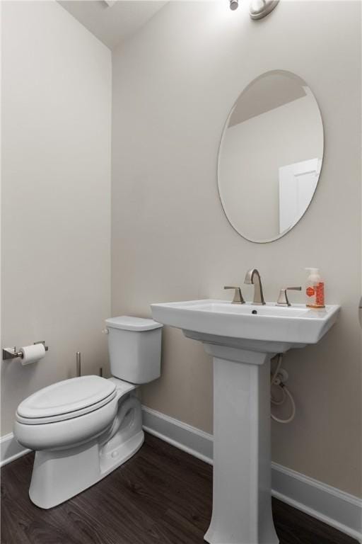 bathroom with wood-type flooring and toilet