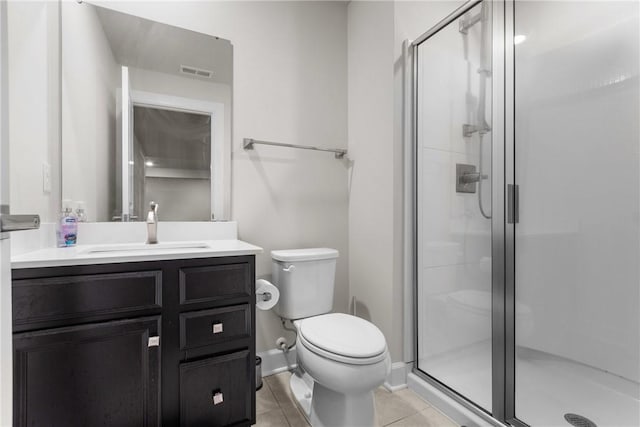 bathroom with vanity, a shower with shower door, tile patterned floors, and toilet