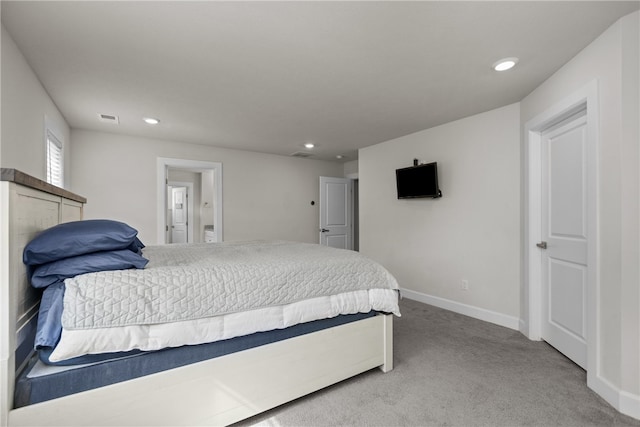 bedroom featuring carpet floors and connected bathroom