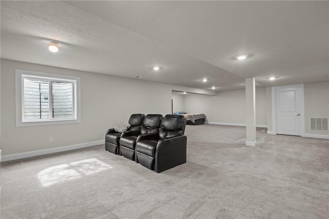 carpeted cinema featuring a textured ceiling