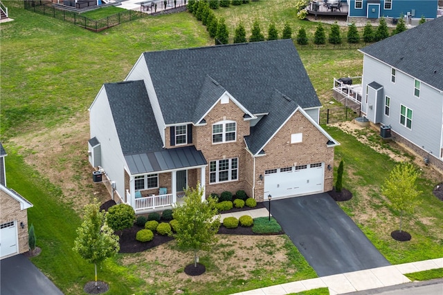 exterior space with a front lawn, a garage, and a porch