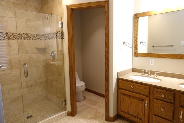 bathroom featuring walk in shower, vanity, tile patterned flooring, and toilet