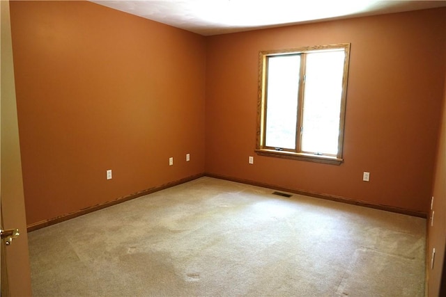 unfurnished room with light carpet