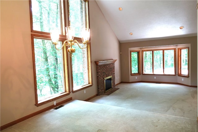 unfurnished living room with a notable chandelier, vaulted ceiling, light carpet, and a brick fireplace