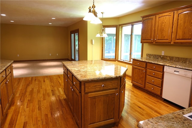 kitchen featuring pendant lighting, an inviting chandelier, dishwasher, light colored carpet, and a kitchen island