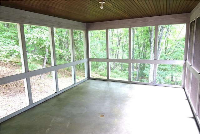 unfurnished sunroom featuring plenty of natural light and wood ceiling