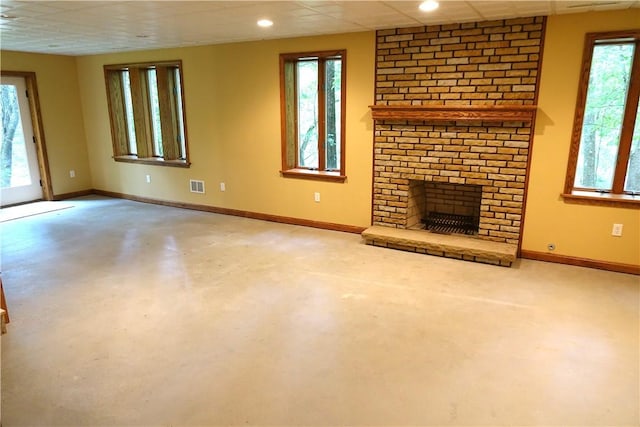 unfurnished living room with a paneled ceiling, plenty of natural light, and a fireplace