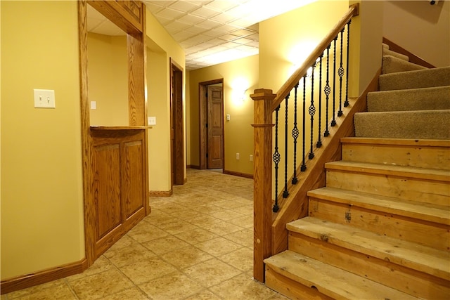 stairway with light tile patterned floors