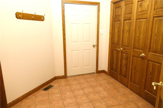 corridor featuring light tile patterned floors