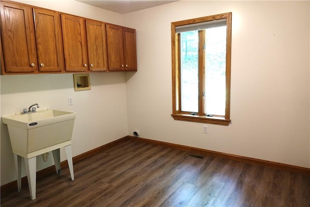 laundry area with cabinets, dark hardwood / wood-style floors, and washer hookup