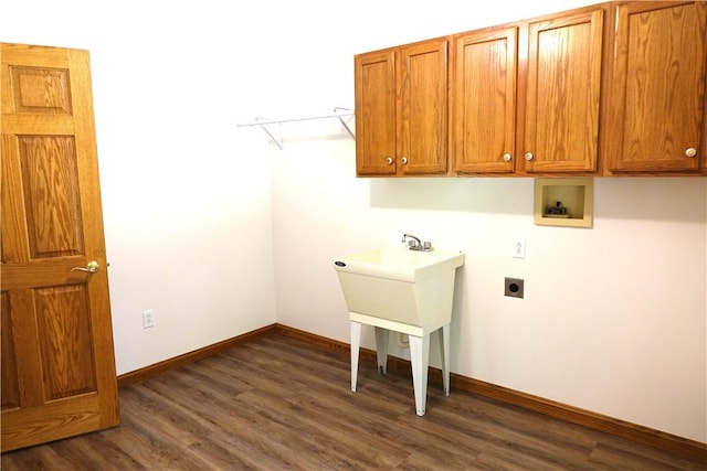 washroom with cabinets, dark hardwood / wood-style flooring, hookup for a washing machine, and electric dryer hookup