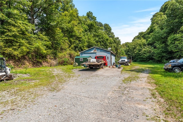 exterior space with a garage and an outbuilding