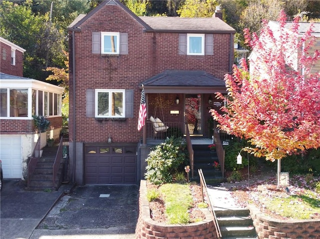 traditional-style home with concrete driveway, a garage, and brick siding