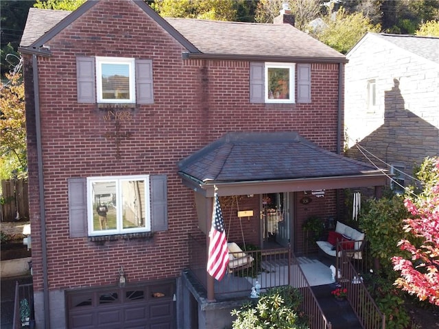 view of front of house featuring an attached garage, brick siding, roof with shingles, and a chimney