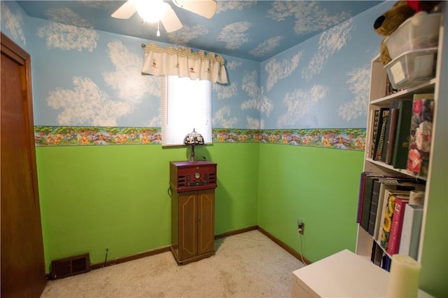 interior space featuring light carpet, visible vents, a ceiling fan, and baseboards