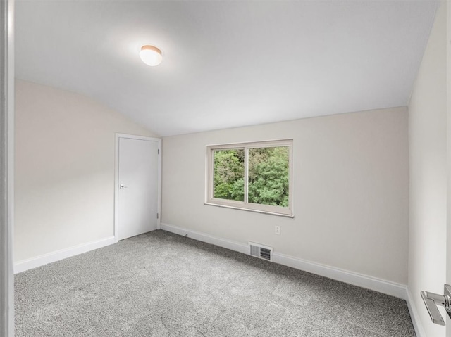 spare room with lofted ceiling and carpet floors