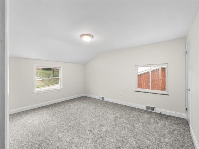 empty room with carpet and lofted ceiling