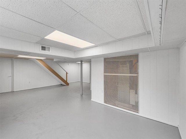 basement featuring a paneled ceiling