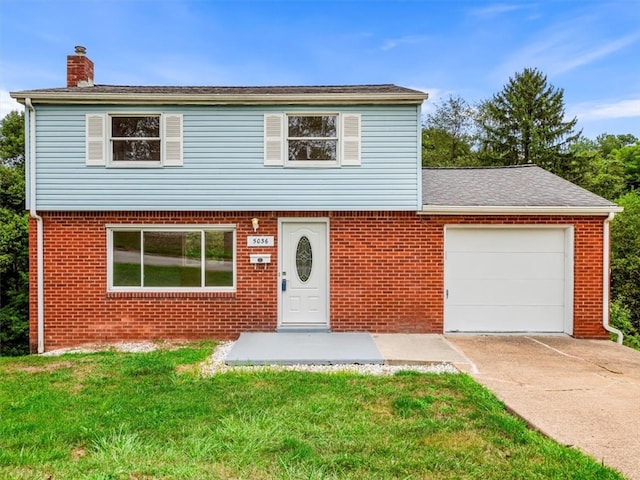 view of front property featuring a front yard and a garage