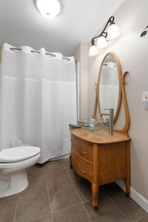 bathroom with tile patterned floors, vanity, and toilet