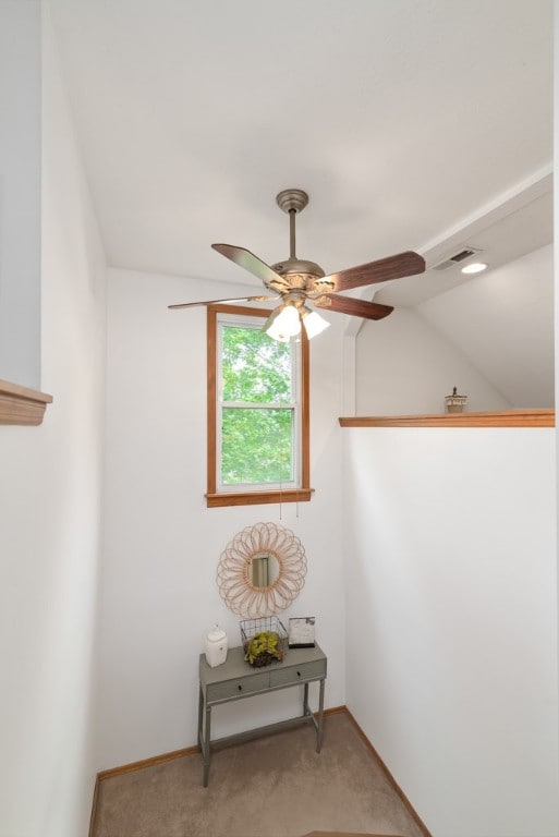 unfurnished room featuring ceiling fan, vaulted ceiling, and carpet floors