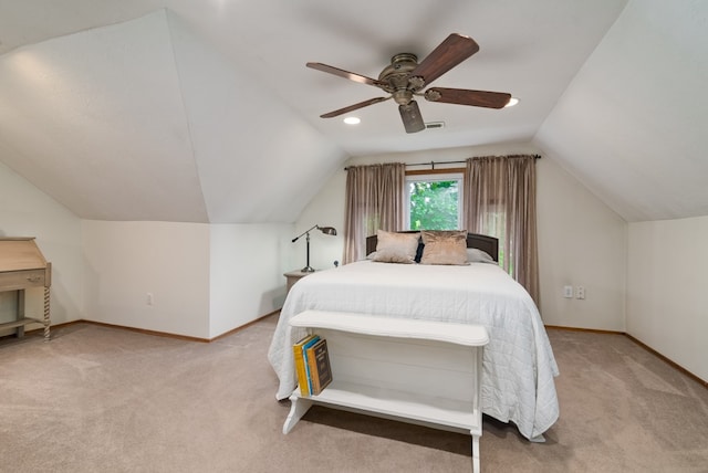 carpeted bedroom with ceiling fan and vaulted ceiling