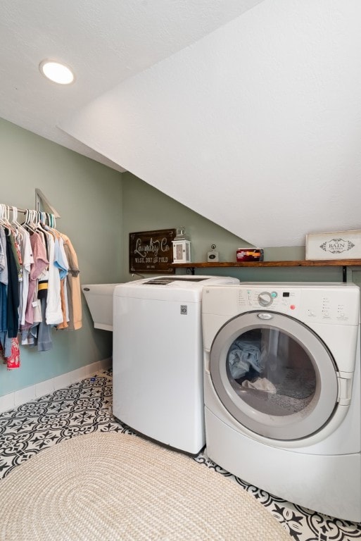 clothes washing area featuring washer and dryer