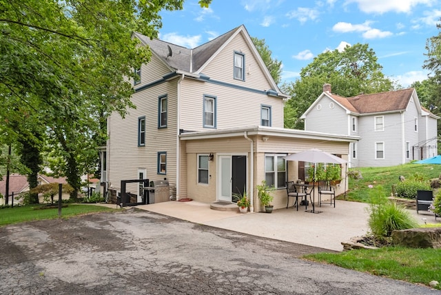 rear view of property with a patio area