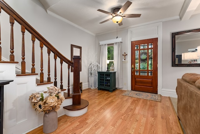 entryway featuring ceiling fan, light hardwood / wood-style floors, and crown molding