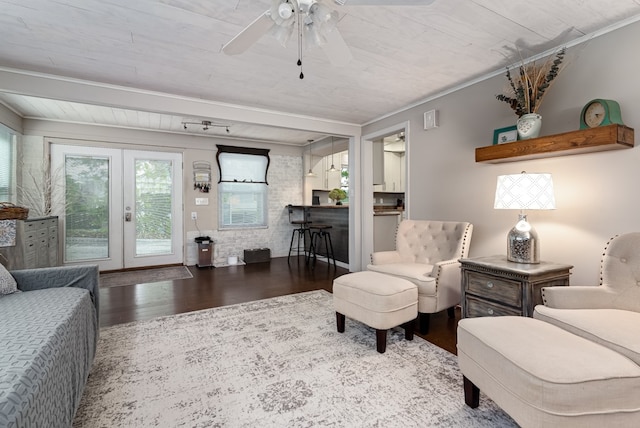 living room with ceiling fan, ornamental molding, french doors, and wood-type flooring