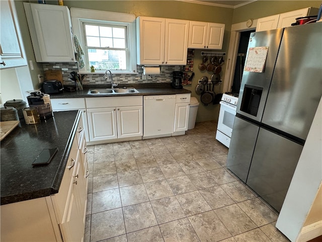 kitchen with backsplash, white appliances, sink, and white cabinetry