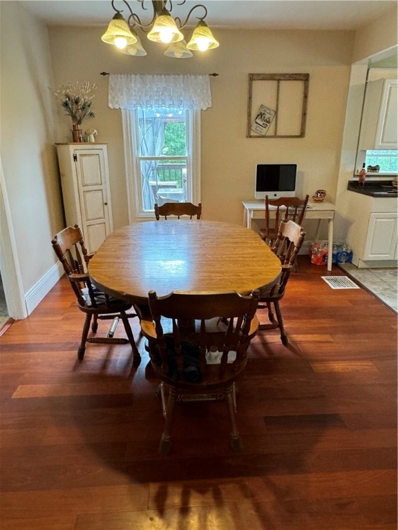 dining room with a notable chandelier and hardwood / wood-style floors