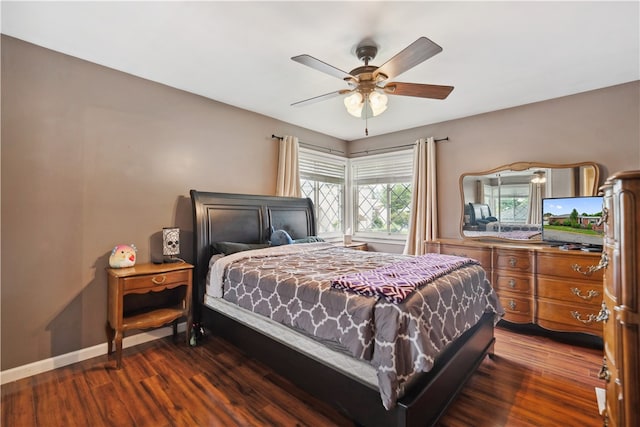 bedroom with dark hardwood / wood-style floors and ceiling fan