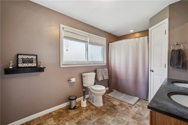 bathroom featuring double sink vanity, tile patterned flooring, and toilet