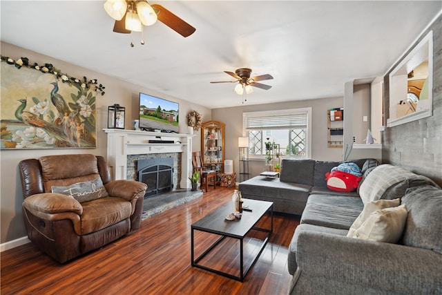 living room featuring ceiling fan and dark hardwood / wood-style floors