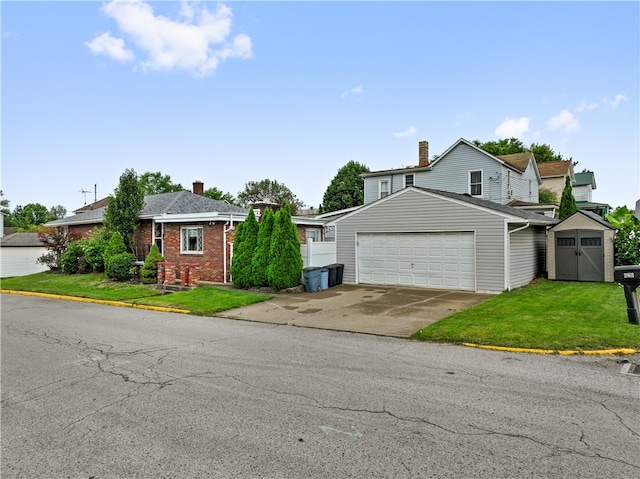 view of front of property featuring a front lawn, a storage shed, and a garage