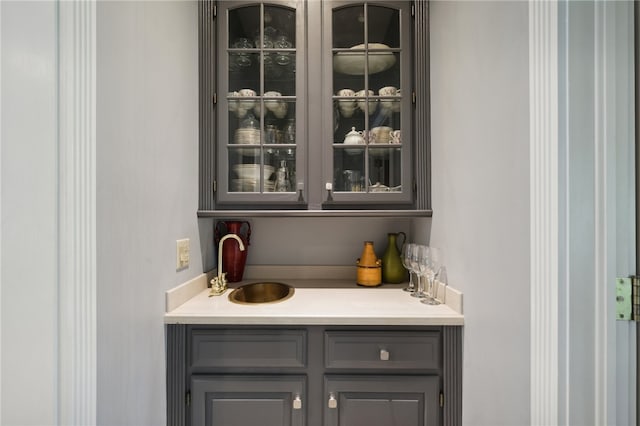 bar with sink and gray cabinets