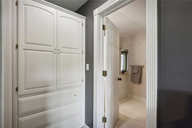 hall with light tile patterned floors