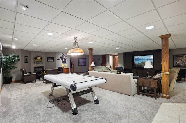 playroom with decorative columns, a drop ceiling, and light carpet