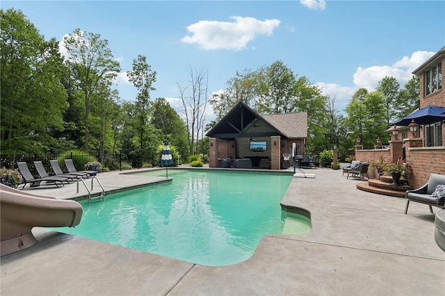 view of swimming pool featuring a patio and a water slide