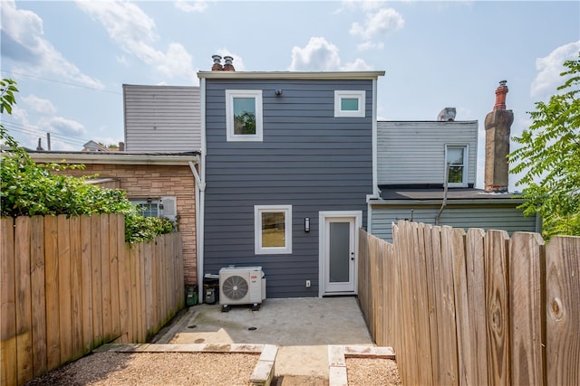 back of house with ac unit and a patio