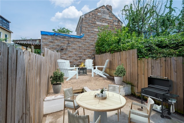 view of patio featuring an outdoor fire pit